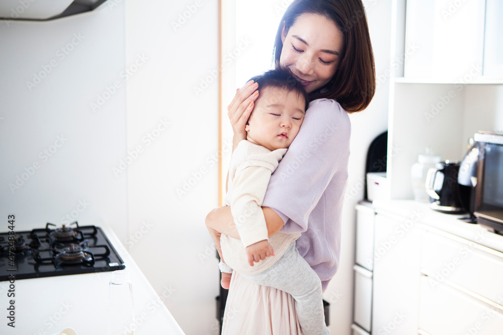 Naklejka premium 眠っている赤子を抱きしめる母親