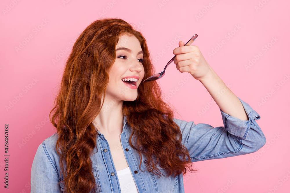 custom made wallpaper toronto digitalPhoto of cute charming young lady dressed jeans shirt eating spoon smiling isolated pink color background