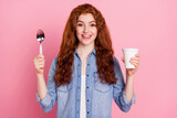 Photo of pretty hungry young woman wear denim shirt showing tongue ready to eat ready quick soup isolated pink color background