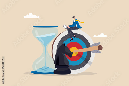 Business strategy, planning to achieve goal, management for company growth opportunity, market success goal, smart businessman working with computer sit on target with chess knight and sandglass.