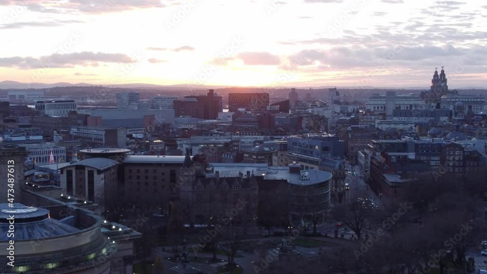 Sunset over Liverpool city contemporary skyline iconic buildings across the horizon aerial view pan left Sunset over Liverpool city contemporary skyline iconic buildings across the horizon aerial view pan left