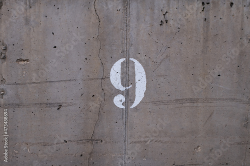 number 9 typed on a wall with a crack through it © Rufino