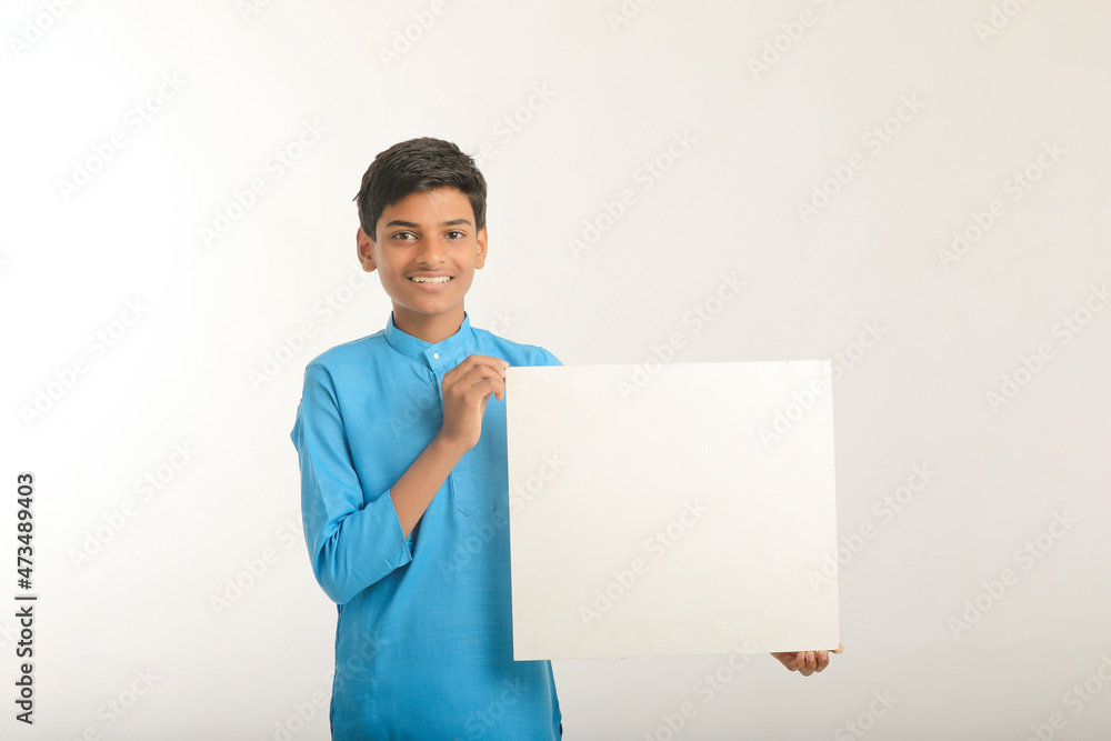 Indian little child in traditional wear and showing white board. Indian little child in traditional wear and showing white board.