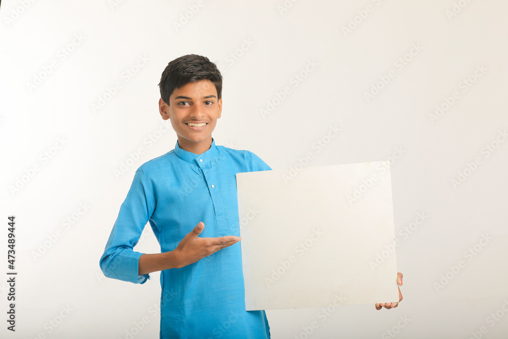 Indian little child in traditional wear and showing white board. Indian little child in traditional wear and showing white board.