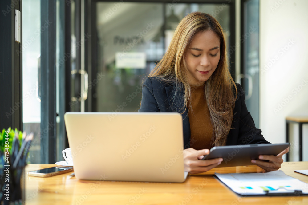 Female assistant or marketing worker working at her desk Female assistant or marketing worker working at her desk