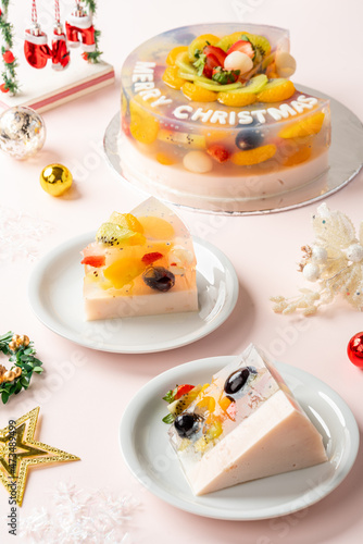 Homemade Fruit Pudding with strawberry, grape, orange, longan, kiwi and peach ingredients decorated with Christmas decorations