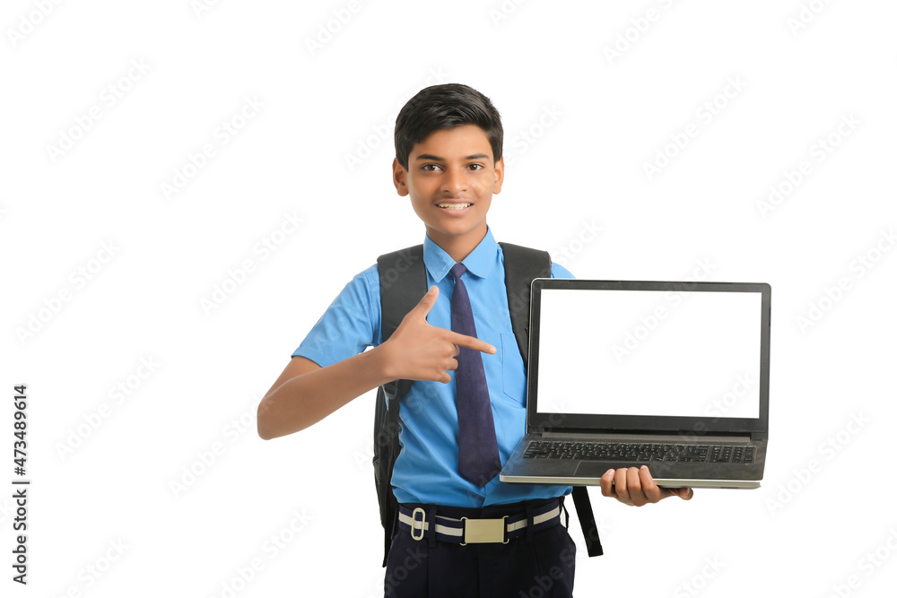 Indian school boy showing laptop screen on white background. Indian school boy showing laptop screen on white background.