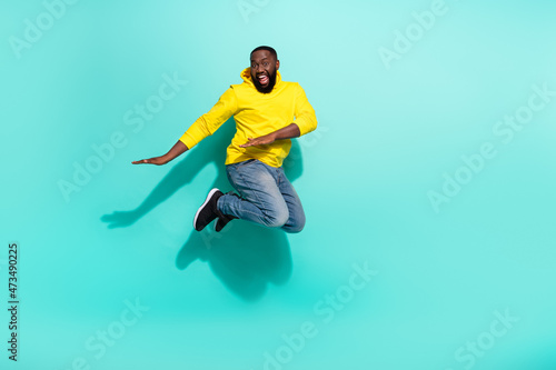 Full size photo of excited guy jump dance autumn bargains isolated over cyan color background