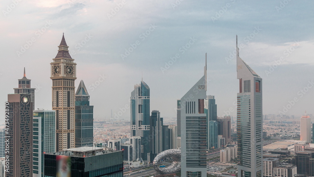 Skyscrapers on Sheikh Zayed Road and DIFC day to night timelapse in Dubai, UAE.