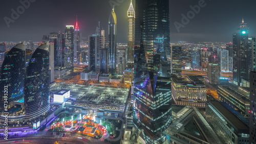 Panorama showing futuristic skyscrapers in financial district business center in Dubai night timelapse