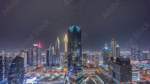 Panorama of futuristic skyscrapers in financial district business center in Dubai all night timelapse