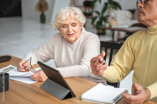 Mature caucasian couple calculating the family budget