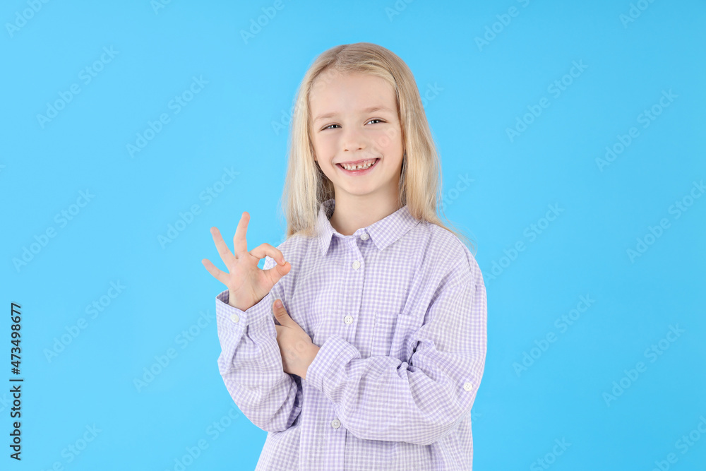 Cute little girl in shirt on blue background Cute little girl in shirt on blue background