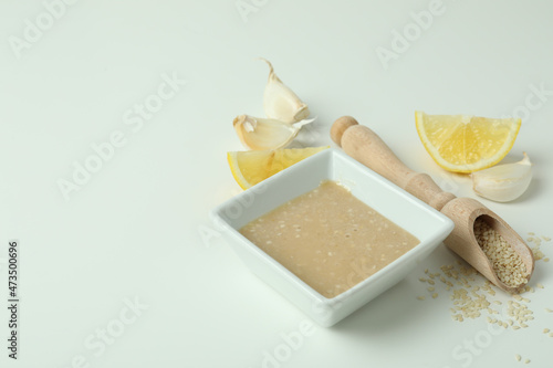 Concept of tasty food with tahini sauce on white background