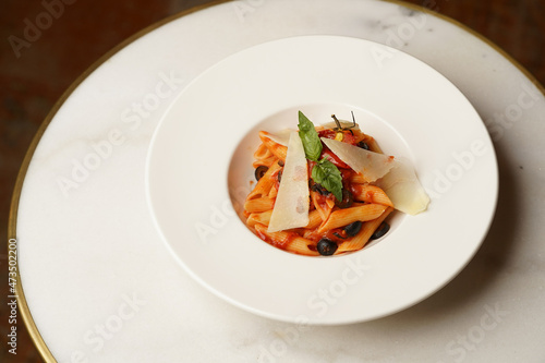 Pasta penne with roasted tomato, olives and cheese