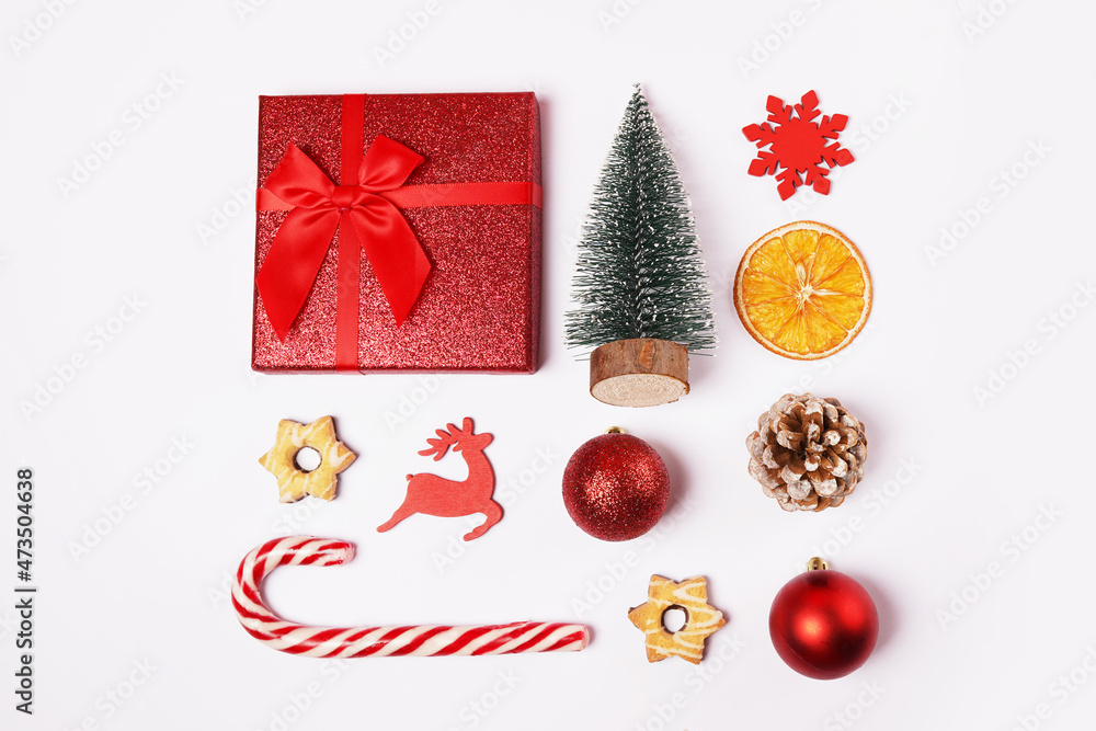 Christmas composition, decorations, fir tree, snowflake, candy cane and toys on white background. Flat lay, top view