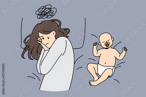 Postpartum depression and parenthood concept. Young depressed sad mother with tough thoughts lying in bed with happy sleeping baby nearby vector illustration 