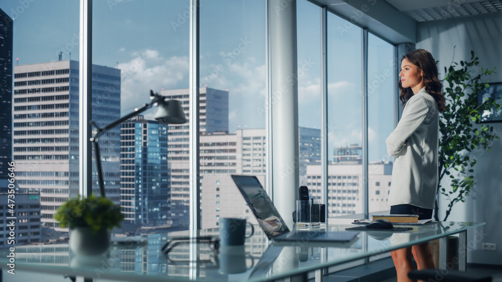 Ambitious Caucasian Businesswoman Standing in Office Looking out of Window on Big City. Confident Overachieving Female Digital Entrepreneur Thinking about Investment Strategy for e-Commerce Software Ambitious Caucasian Businesswoman Standing in Office Looking out of Window on Big City. Confident Overachieving Female Digital Entrepreneur Thinking about Investment Strategy for e-Commerce Software