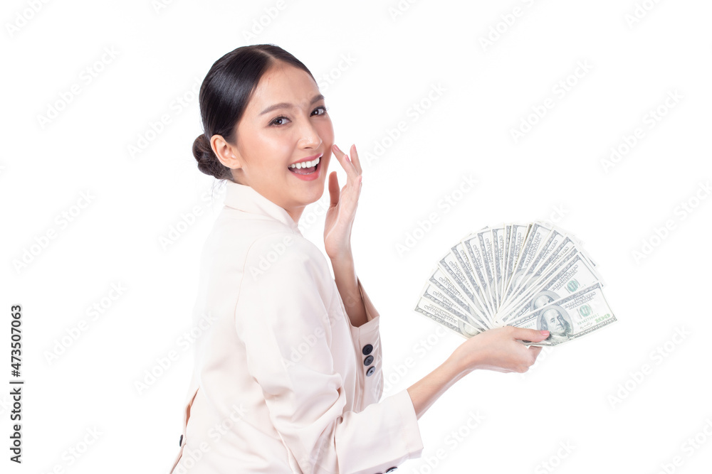 Portrait of a beautiful young Asian woman in suit holding dollar money banknotes, money exchange service. Studio shot isolated on white background. Portrait of a beautiful young Asian woman in suit holding dollar money banknotes, money exchange service. Studio shot isolated on white background.
