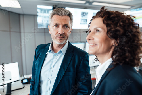Businessman standing by female colleague at headquarter