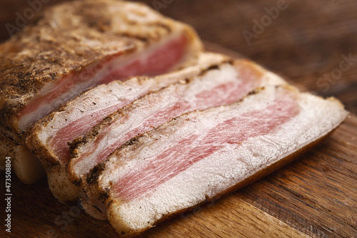 Fotografija Chopped dry-cured pork cheeks - Italian guanchiale close-up