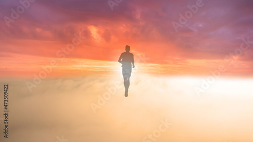 Silhouette of a man walking into the sunset, symbolic of dying
