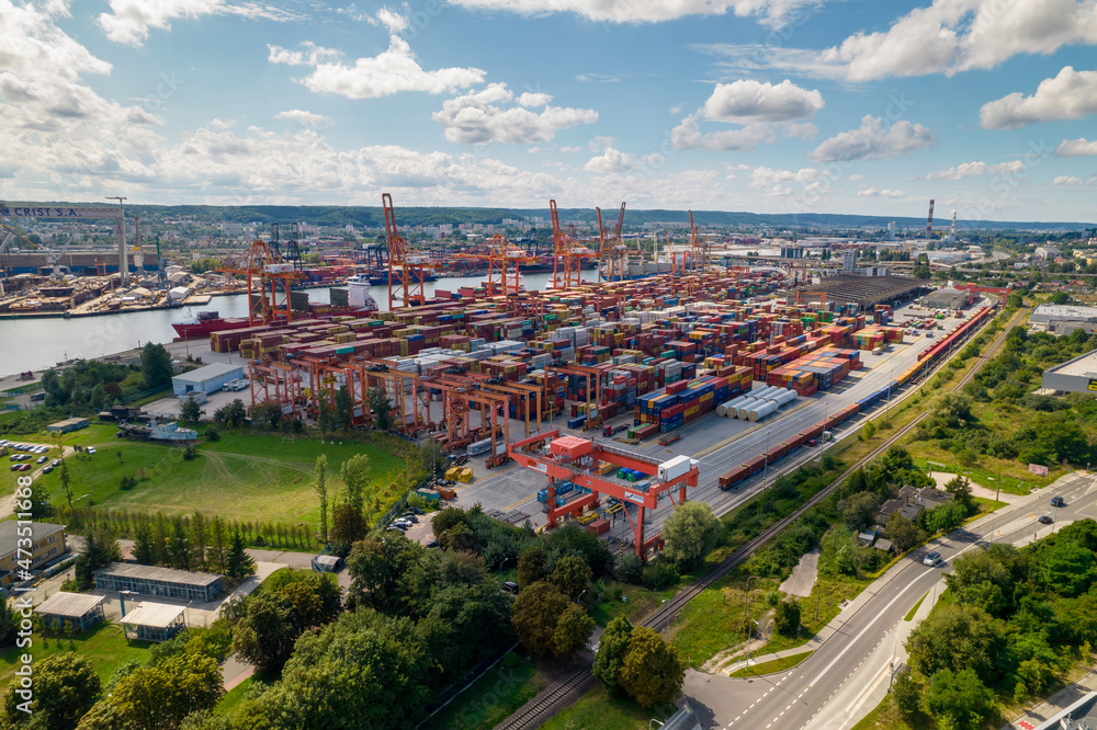 Port of Gdynia. Seaport, containers, container ships and sea transport from the bird's eye view on a sunny day.