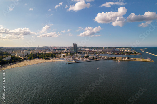 Gdynia city by the sea on a sunny day from a drone. Summer colors and sun rays in Gdynia.