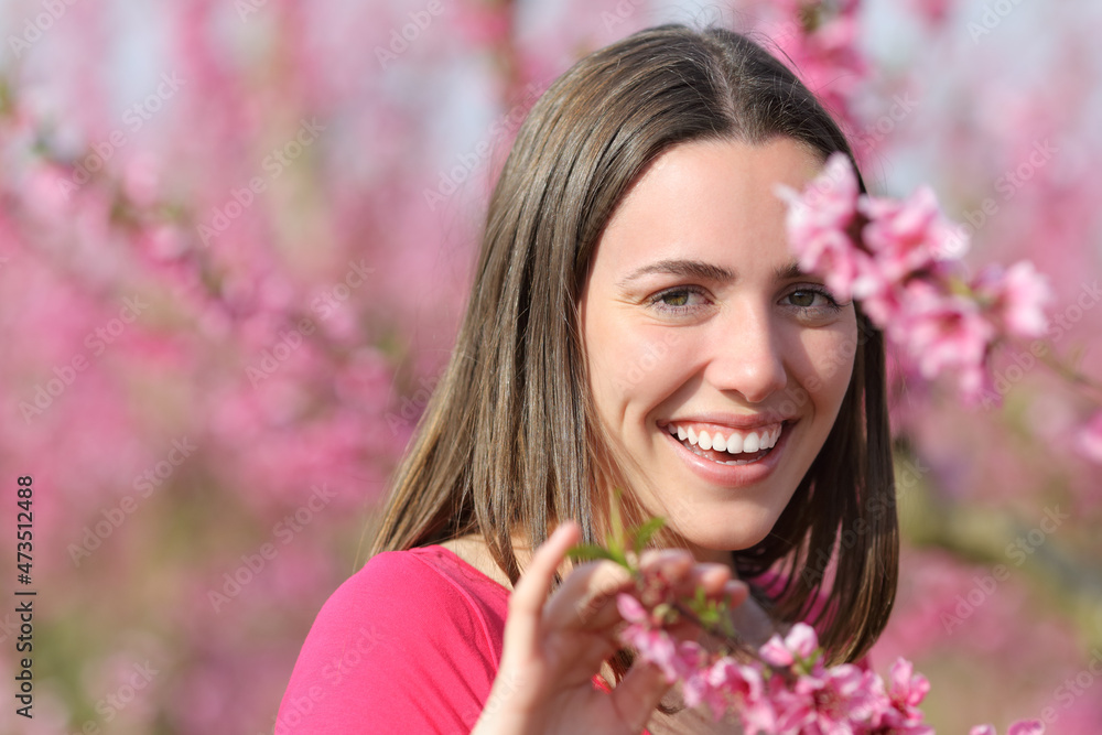 Woman smiling with perfect teeth in a field Woman smiling with perfect teeth in a field