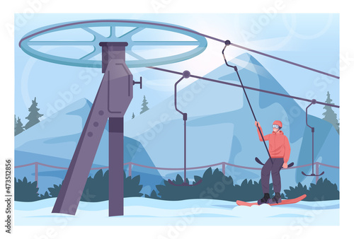 Snowboarder lifting up with surface lift. Winter ski resort, ski