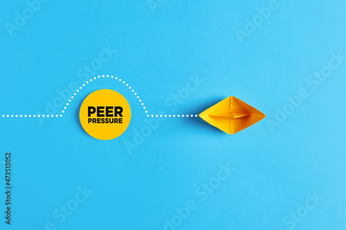 Paper boat overcomes the obstacle of peer pressure. To avoid or to deal with peer pressure photo