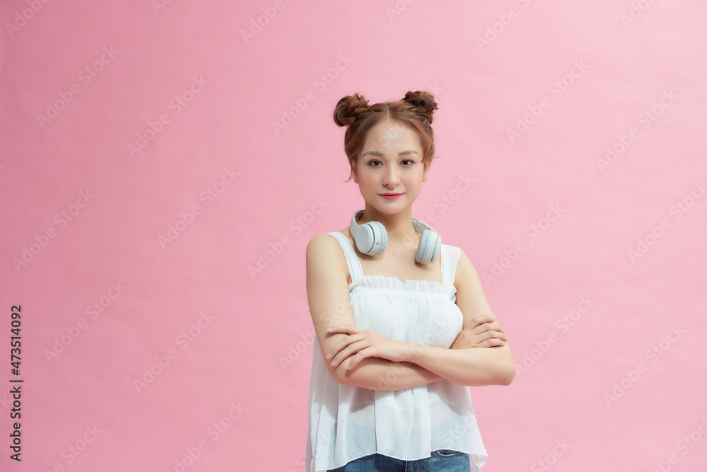 Casual woman smiling with arms crossed - isolated over pink Casual woman smiling with arms crossed - isolated over pink