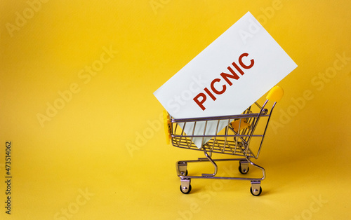 The word Picnic in a basket on a yellow background