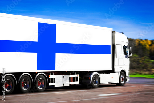 Finland Flag on White Semi Trailer Truck. Motion blur effect. 