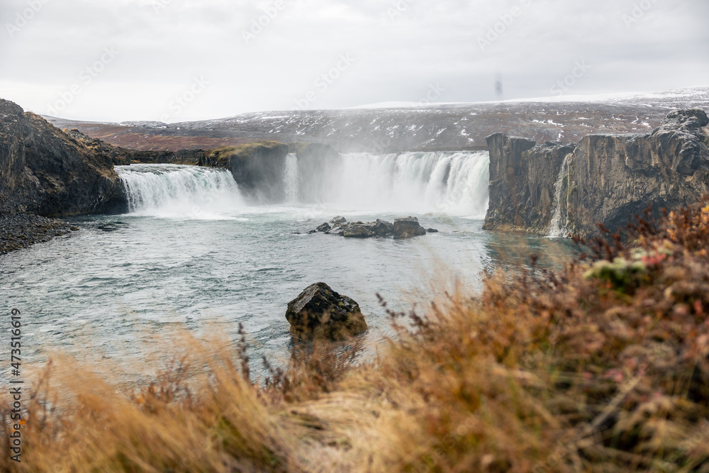 Fototapeta premium Goðafoss Waterfall Iceland in autum with yellow green orange grass