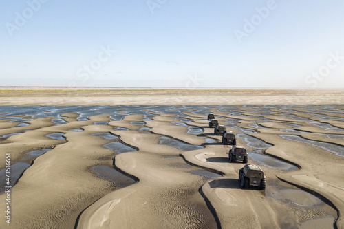 Amphibious offroad vehicles moving thru deserted mouth of the river lena in Yakutia
 photo