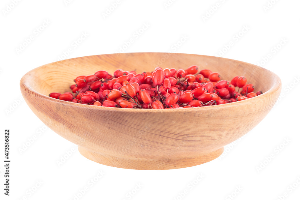 barberries in wooden plate isolated on white background barberries in wooden plate isolated on white background