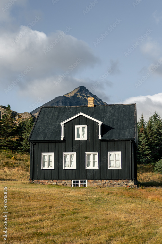 Teigarhorn Farm view to mountain from the ocean with blues sky and clouds