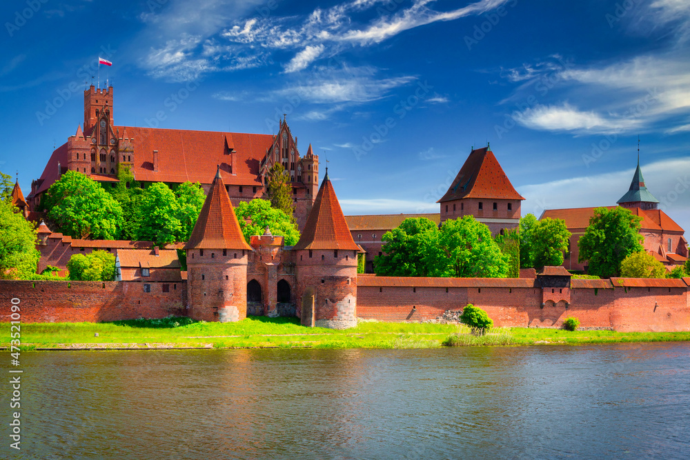Naklejka premium Malbork castle by the Nogat river at summer, Poland.