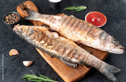 grilled sea bass fish on a stone background