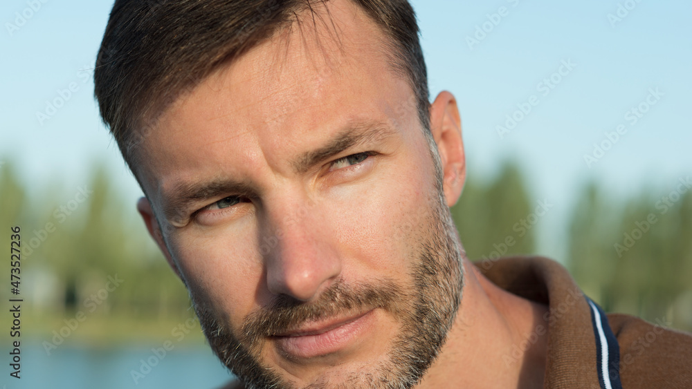 Fototapeta premium Portrait of a man with a beard looking aside.