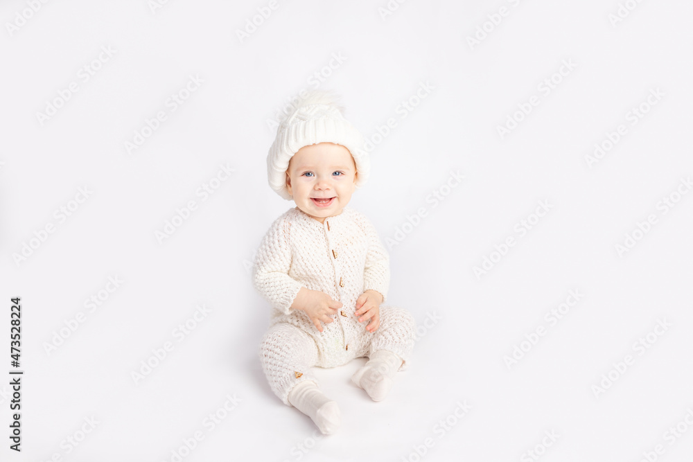 baby in a warm suit and hat on a white isolated background, space for text baby in a warm suit and hat on a white isolated background, space for text