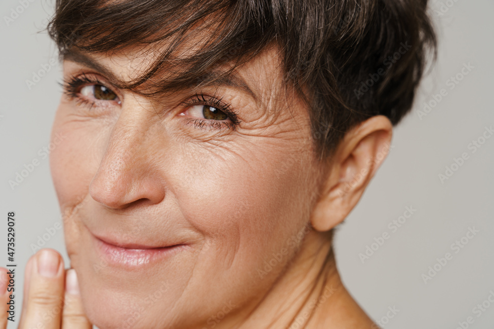 Mature european woman smiling and looking at camera Mature european woman smiling and looking at camera