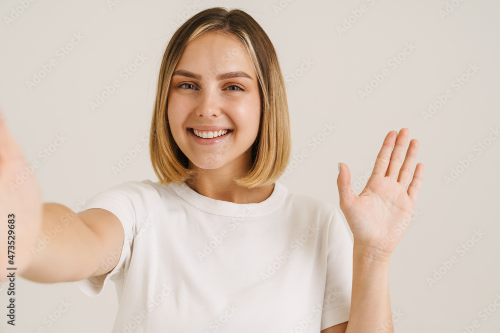 Young blonde woman gesturing while taking selfie photo Young blonde woman gesturing while taking selfie photo