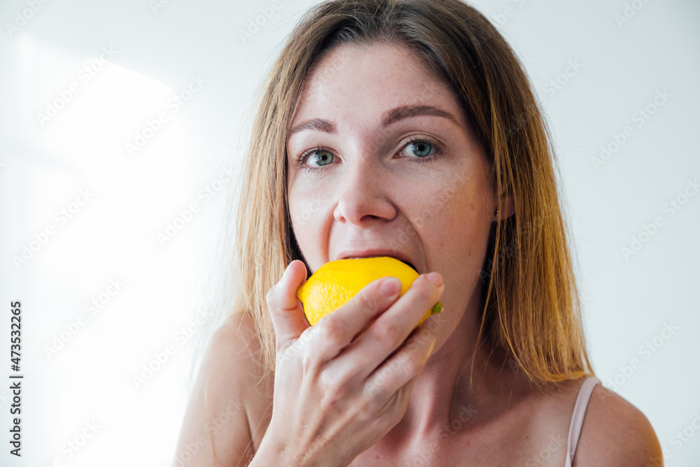 beautiful blonde woman eating yellow sour lemon beautiful blonde woman eating yellow sour lemon
