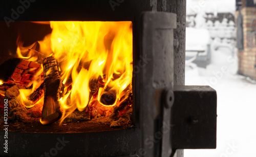 Outdoor oven with lit fire in winter. Burning coals. Close up