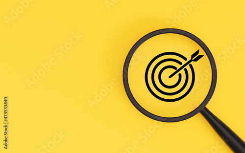 Target board inside of magnifier glass on yellow background and copy space for focus business objective achievement concept by 3d rendering.