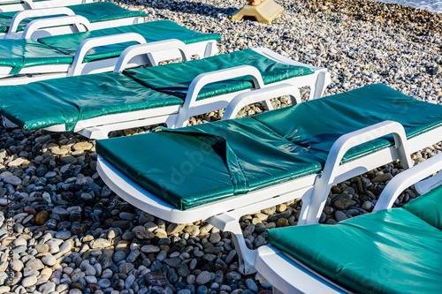Wallpaper Mural Empty chaise lounges on pebble at the beach Torontodigital.ca