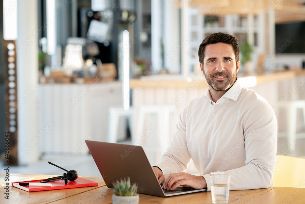 Male professional working on laptop at office Male professional working on laptop at office