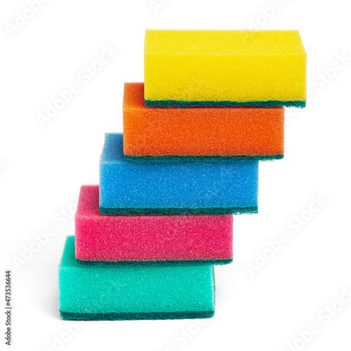 Lot of foam sponges for washing dishes and cleaning in kitchen. Beautiful pyramid of five sponges of yellow, orange, blue, pink and green colors on white background. Closeup view, vertical composition